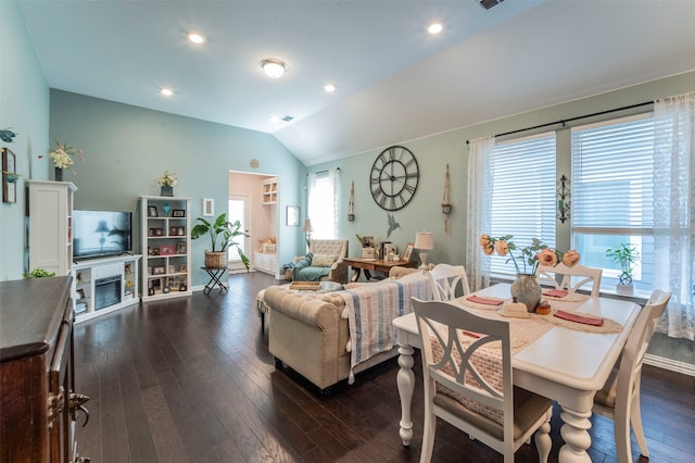 dining space with dark wood-type flooring and lofted ceiling