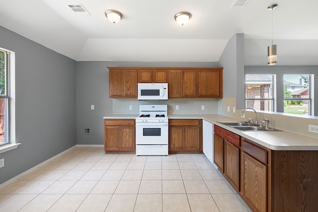 kitchen with plenty of natural light, sink, pendant lighting, and white appliances