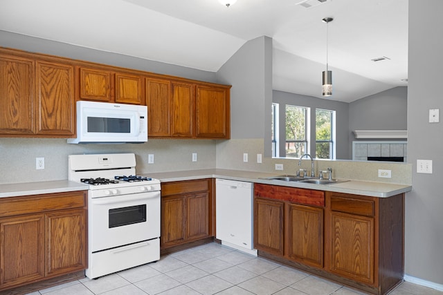 kitchen with decorative light fixtures, lofted ceiling, sink, light tile patterned floors, and white appliances