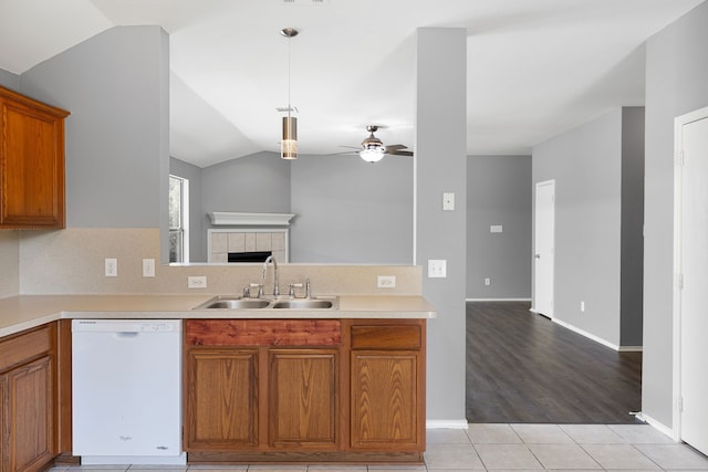 kitchen with lofted ceiling, sink, hanging light fixtures, dishwasher, and ceiling fan