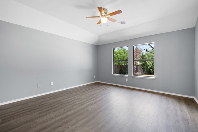 empty room featuring ceiling fan, lofted ceiling, and dark hardwood / wood-style flooring