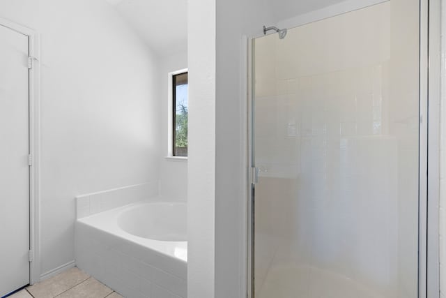 bathroom with tile patterned flooring and shower with separate bathtub