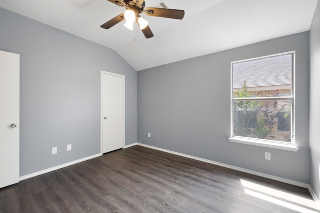 unfurnished room with ceiling fan, lofted ceiling, and dark hardwood / wood-style flooring