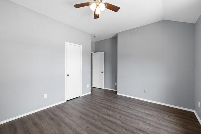 unfurnished bedroom featuring lofted ceiling, dark hardwood / wood-style floors, and ceiling fan