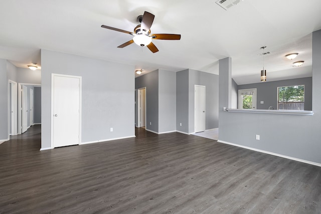 unfurnished living room featuring ceiling fan, dark hardwood / wood-style flooring, and vaulted ceiling