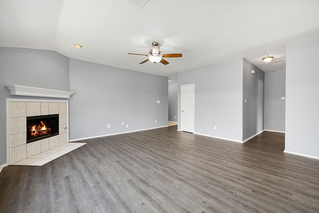 unfurnished living room featuring a fireplace, wood-type flooring, ceiling fan, and vaulted ceiling