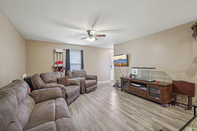 living room with ceiling fan and light hardwood / wood-style floors