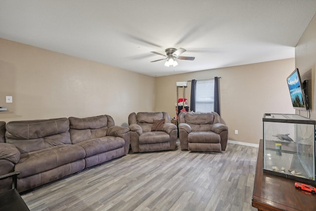 living room featuring ceiling fan and light hardwood / wood-style flooring