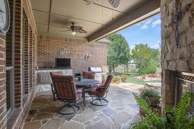 view of patio featuring ceiling fan and an outdoor kitchen