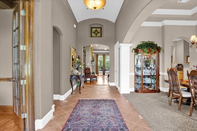 entryway with french doors, light tile patterned flooring, and ornamental molding