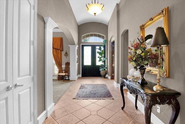 entrance foyer with lofted ceiling and light tile patterned flooring