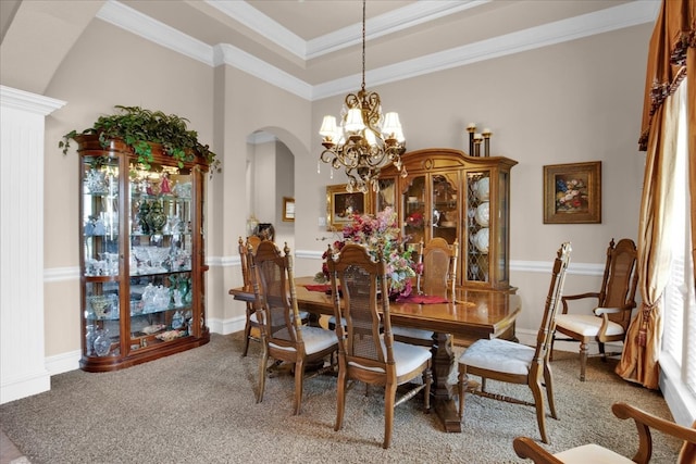 carpeted dining space with crown molding and an inviting chandelier