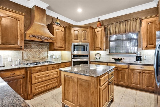 kitchen featuring custom exhaust hood, stainless steel appliances, tasteful backsplash, dark stone counters, and a center island