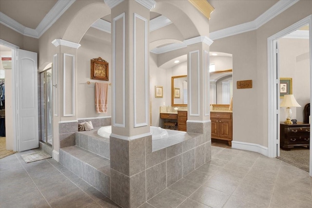 bathroom featuring ornate columns, plus walk in shower, tile patterned flooring, ornamental molding, and vanity