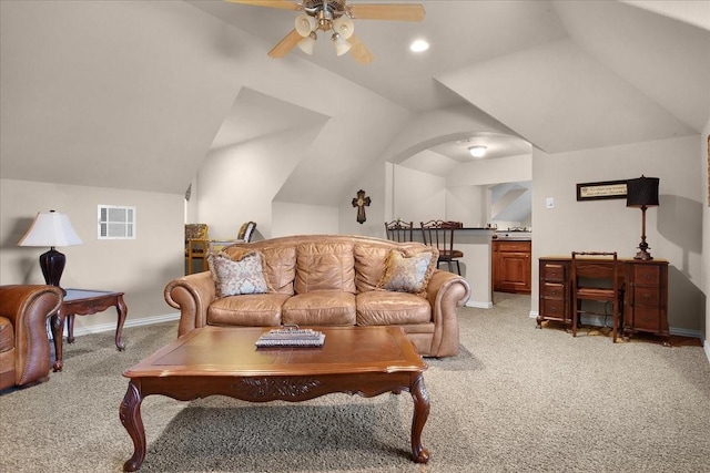 living room featuring vaulted ceiling, ceiling fan, and light colored carpet