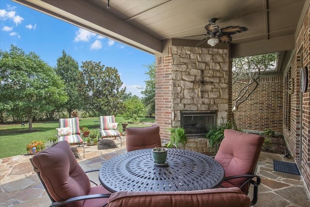 view of patio featuring ceiling fan and an outdoor stone fireplace