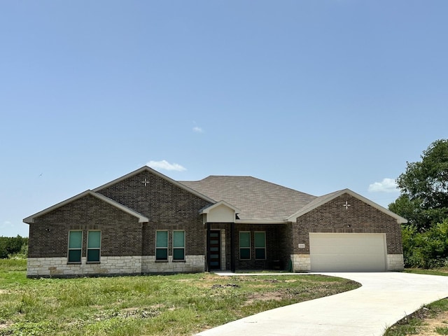 view of front facade with a garage and a front lawn