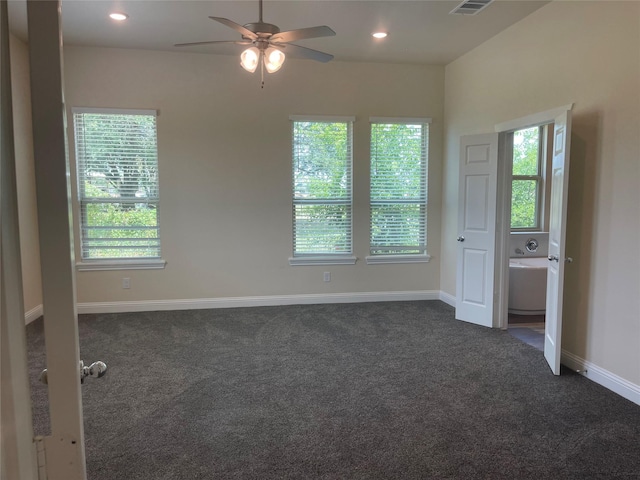 carpeted spare room with ceiling fan and a healthy amount of sunlight