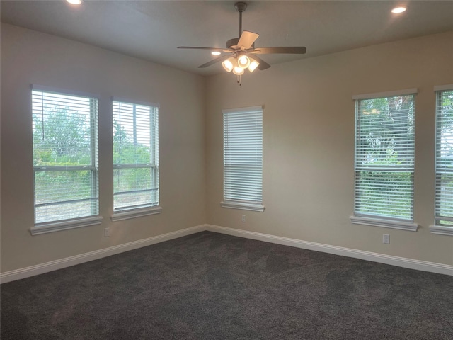 carpeted empty room featuring ceiling fan