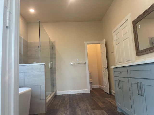 full bathroom with toilet, vanity, shower with separate bathtub, and hardwood / wood-style floors