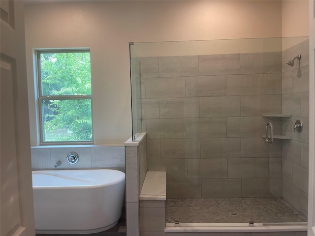 bathroom featuring independent shower and bath