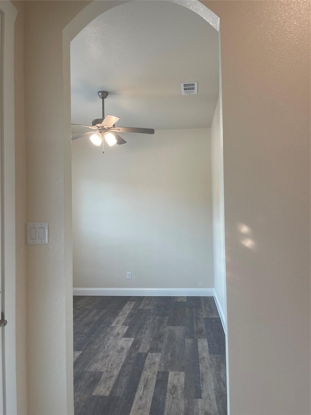 spare room with ceiling fan and dark hardwood / wood-style flooring