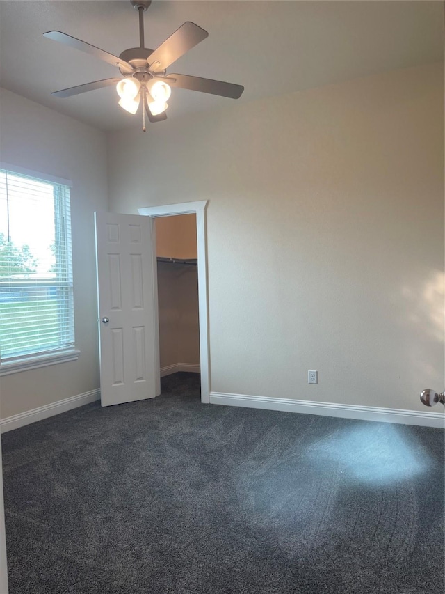 carpeted spare room featuring ceiling fan