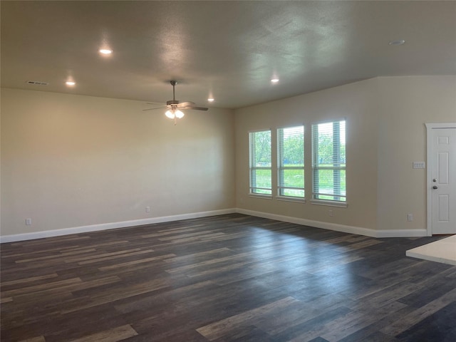 spare room with dark hardwood / wood-style floors and ceiling fan