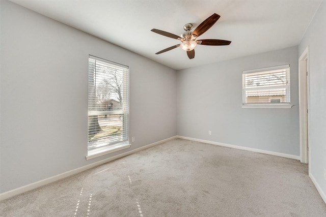 unfurnished room featuring ceiling fan, carpet flooring, a wealth of natural light, and baseboards