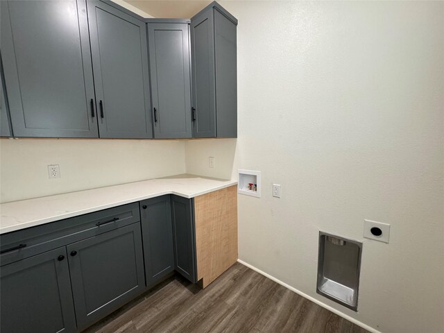 laundry area with dark hardwood / wood-style flooring, electric dryer hookup, hookup for a washing machine, and cabinets