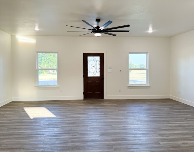 foyer with ceiling fan and dark hardwood / wood-style flooring