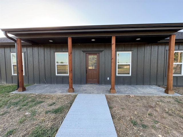 doorway to property featuring a patio area and board and batten siding