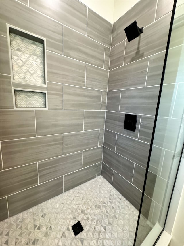 bathroom with a tile shower