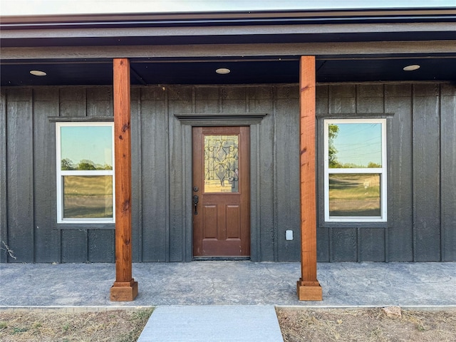 view of exterior entry featuring board and batten siding