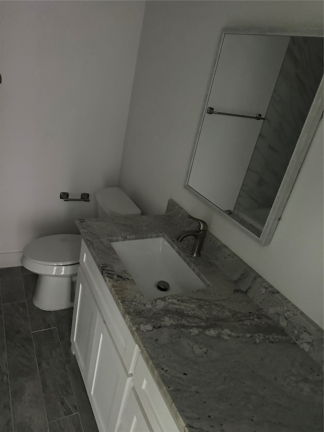 bathroom with tile patterned floors, vanity, and toilet