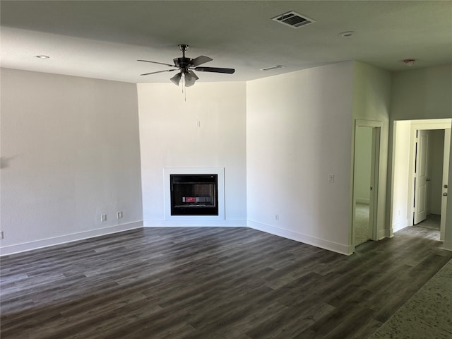 unfurnished living room with ceiling fan and dark hardwood / wood-style flooring