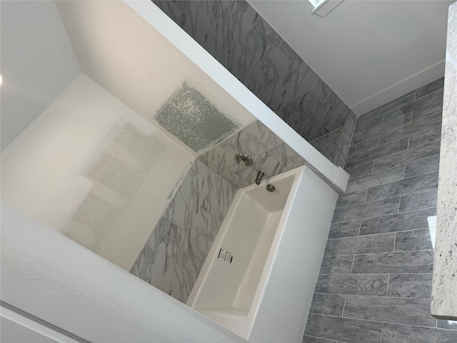 interior space featuring tile patterned flooring and a tile shower