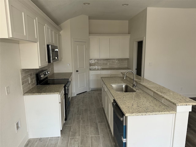 kitchen with sink, white cabinets, electric stove, and decorative backsplash