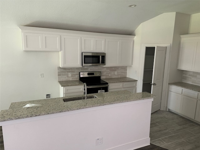 kitchen featuring sink, white cabinetry, tasteful backsplash, and stainless steel appliances