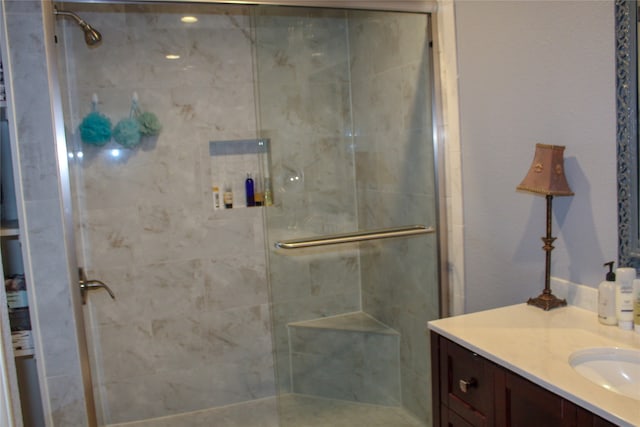 bathroom with walk in shower and vanity