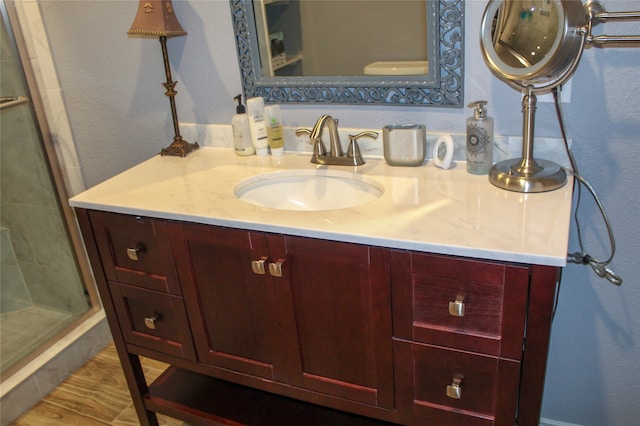 bathroom featuring vanity and a shower with shower door