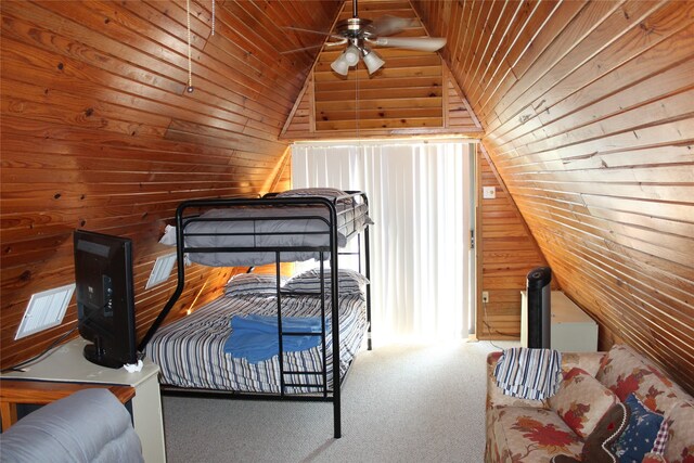 carpeted bedroom with wooden walls, vaulted ceiling, and wooden ceiling