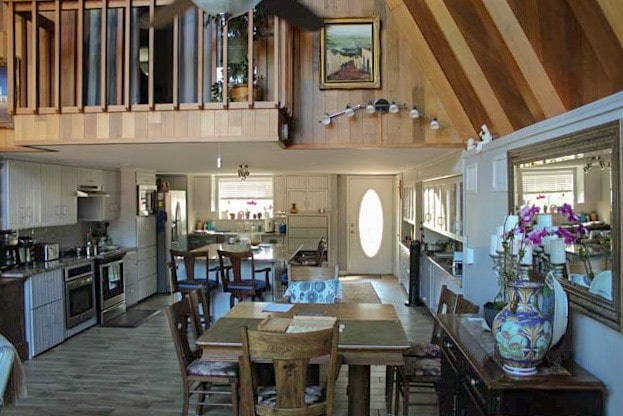 dining room featuring high vaulted ceiling