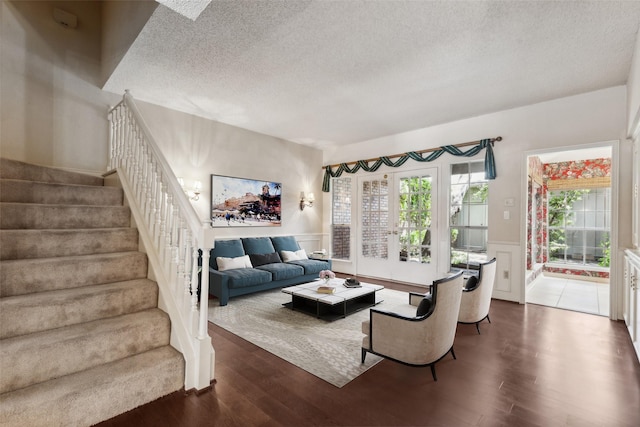 living room with dark wood-type flooring and a textured ceiling