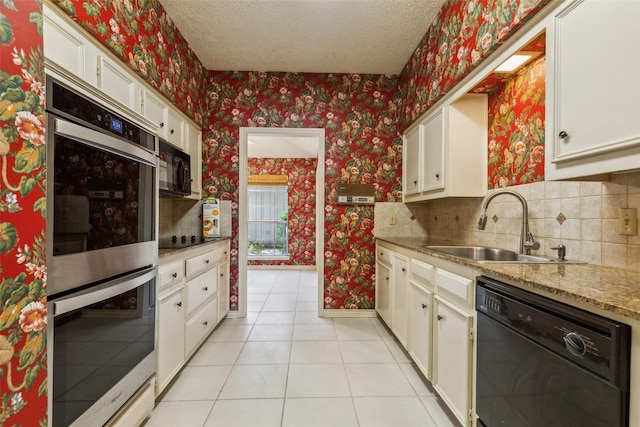 kitchen featuring sink, backsplash, light tile patterned floors, black appliances, and a textured ceiling