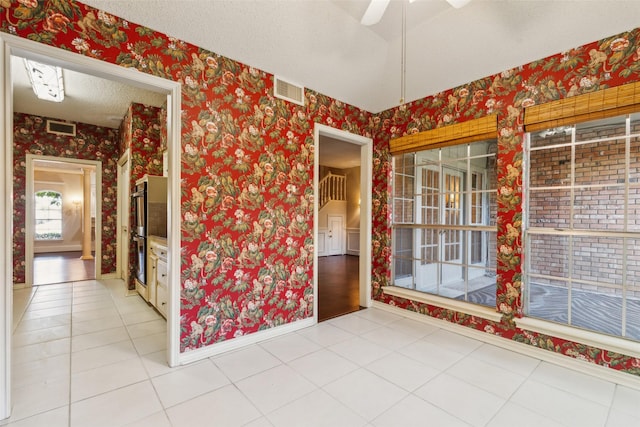 interior space featuring ceiling fan and a textured ceiling