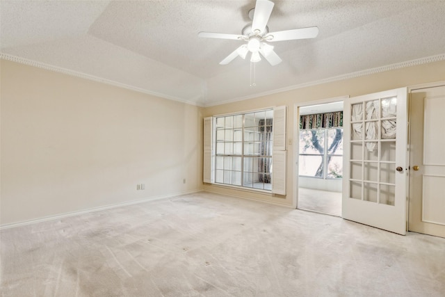 carpeted spare room with crown molding, vaulted ceiling, a textured ceiling, a tray ceiling, and ceiling fan