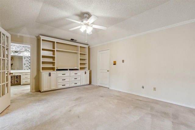 unfurnished living room featuring light carpet, a textured ceiling, ornamental molding, and ceiling fan