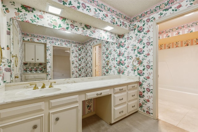 bathroom featuring vanity and a textured ceiling