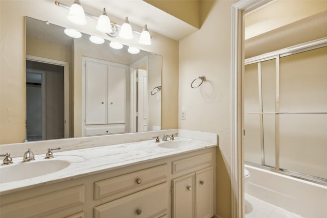 full bathroom with vanity, shower / bath combination with glass door, and toilet